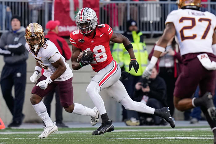 Ohio State Buckeyes wide receiver Marvin Harrison Jr. (18) runs past Minnesota Golden Gophers defensive back Justin Walley (5) after making a catch during the first half of the NCAA football game at Ohio Stadium.